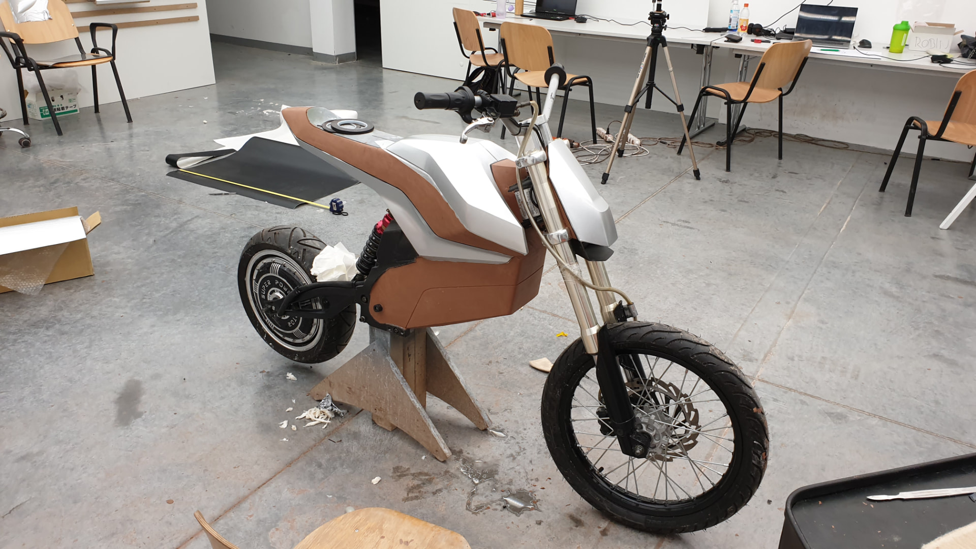Clay prototype with silver and brown surfaces during final detailing